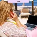 A blonde woman sitting in a chair on the beach with a phone on a beach and a laptop
