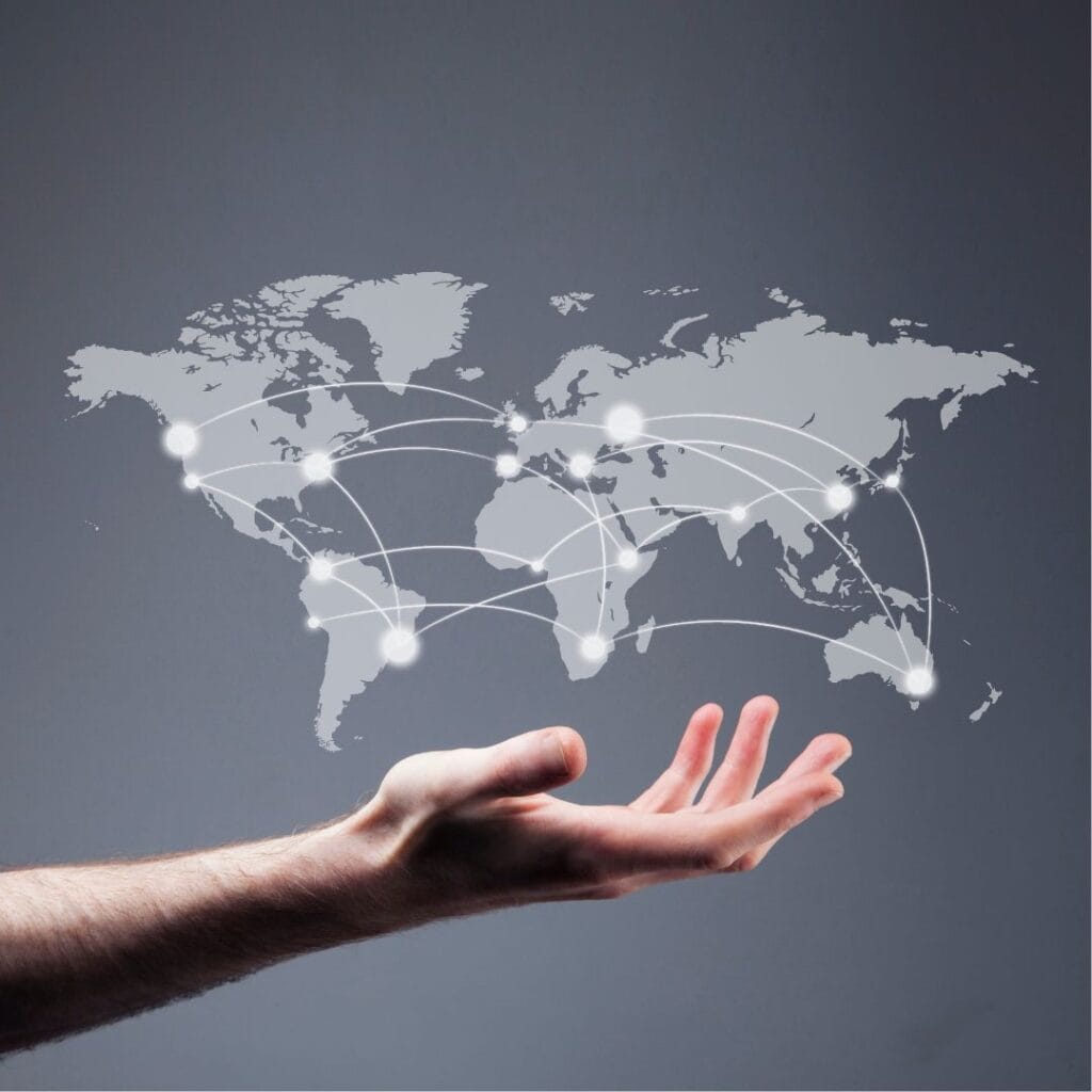a hand is holding a world map with connections on a gray background