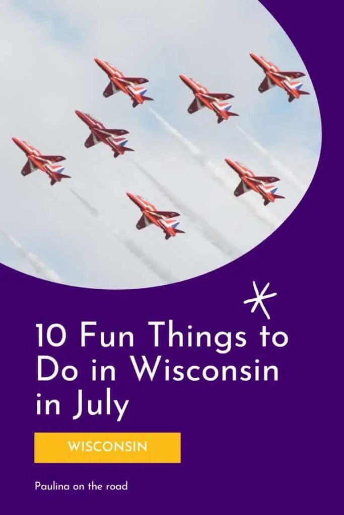 View of red airplanes flying in formation through a clear blue sky whilst spraying out white vapor behind them