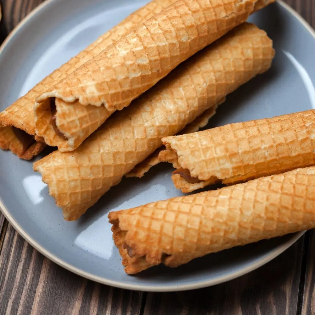 Wäffelcher or crispy waffle cones served in blue plate