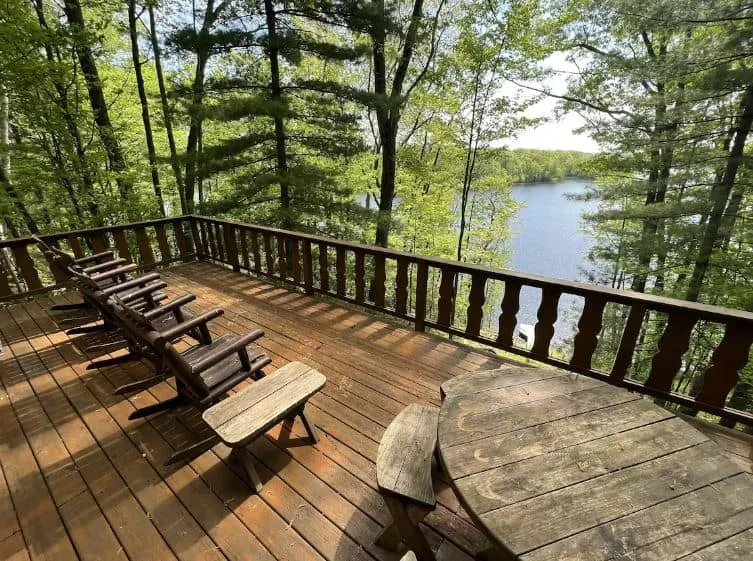 deck with lake view and chairs at the Lakefront Chalet in Florence, Wisconsin