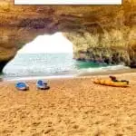 Pinterest pin about fun things to do in albufeira in june showing photo of benagil cave interior with sandy beach and blue and yellow kayaks