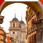 Pinterest pin about unique things to book in madrid showing photo of arch with colorful buildings in backdrop