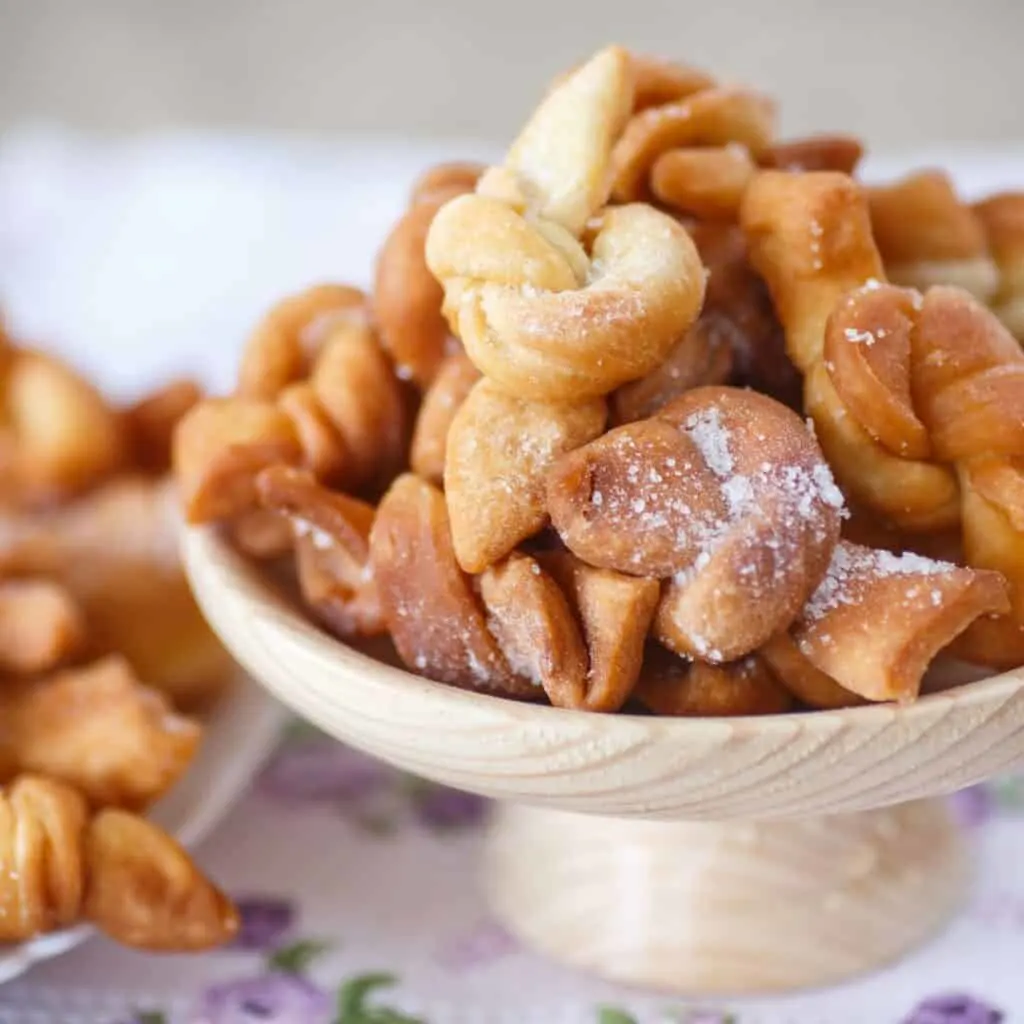 verwurelter deep fried donut knots with powdered sugar, traditional luxembourg desserts