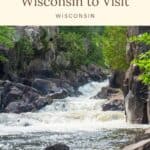 gushing water flowing from dave's falls in wisconsin surrounded by large rocky formations