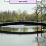 a bridge over a lake with its reflection on the lake inside a park