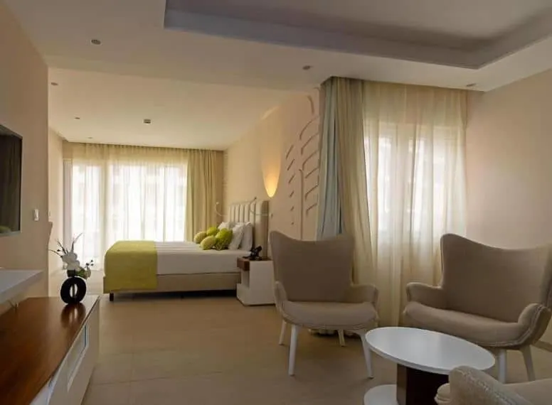 bedroom with sitting area and TV at Luna Boutique Hotel in Mindelo, Sao Vicente, Cape Verde