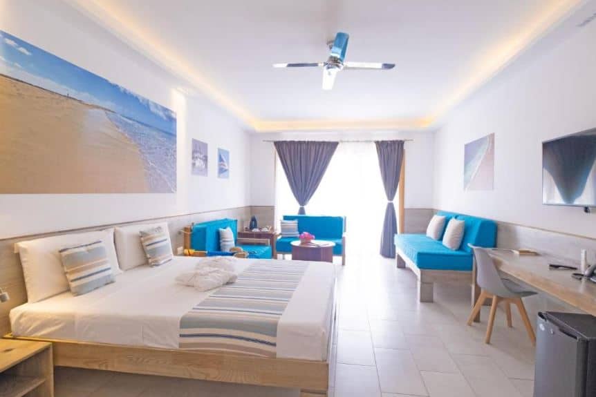 big bedroom with bed and sofas at Sobrado Boutique Hotel in Santa Maria, Sal in Cape Verde