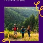 Pinterest pin about hiking in Luxembourg showing photo of three hikers standing in grassy hill taking in the mountain views