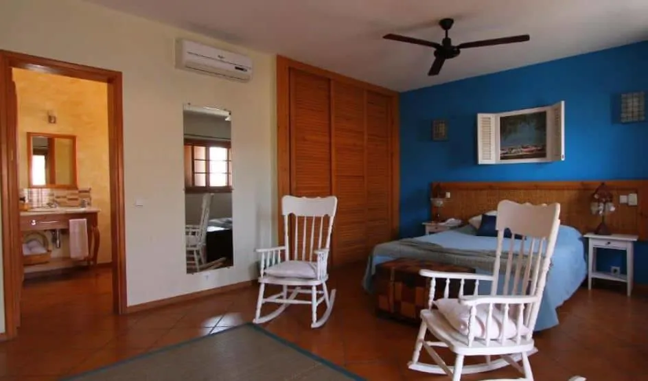 large room with bed, 2 chairs at Kira’s Boutique Hotel in Mindelo, Sao Vicente, Cape Verde