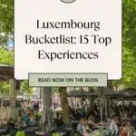 A Pinterest pin about Luxembourg Bucketlist showing a town square with plenty of people dining al fresco amid lush greenery and trees.