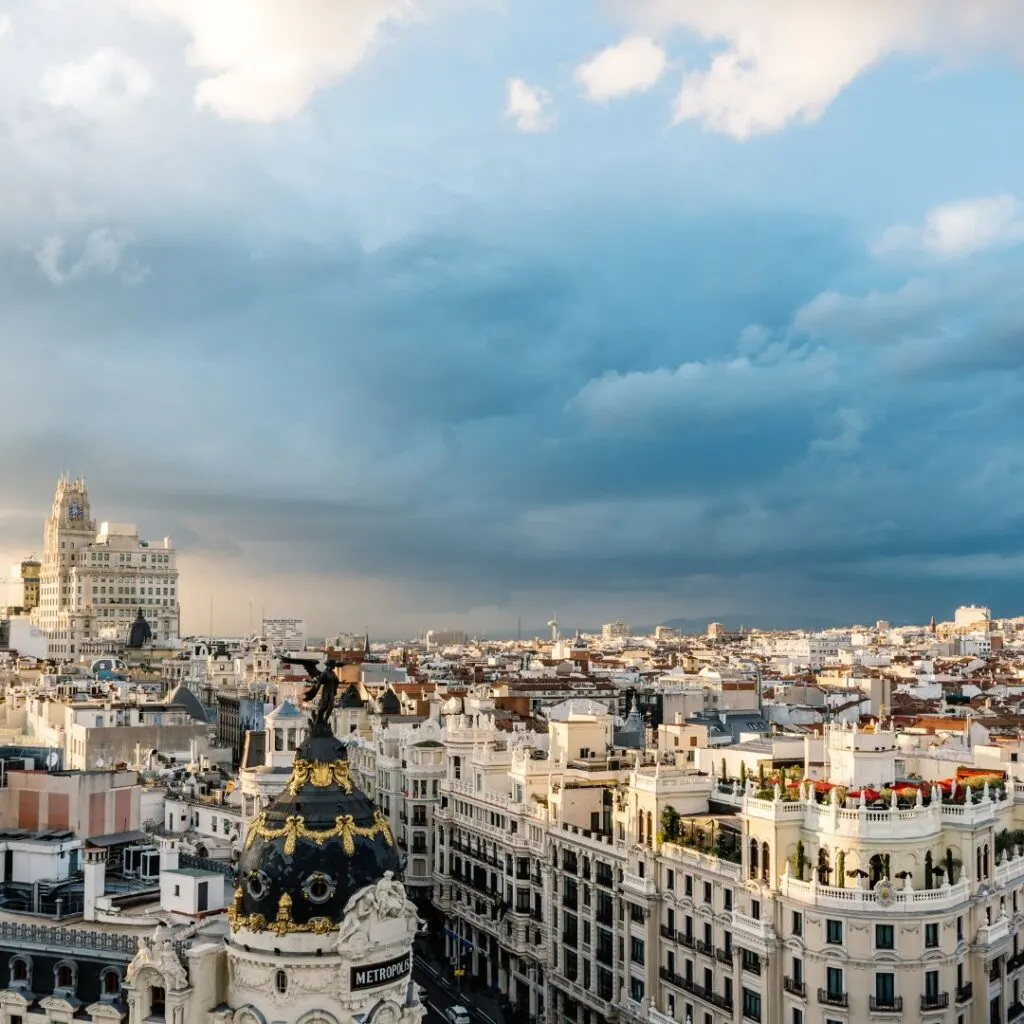 A photo taken from the rooftop terrace of the Círculo de Bellas Artes, a private social club and cultural center in Madrid, Spain. The photo shows a panoramic view of the city skyline in the daytime.