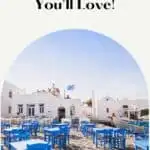 a pin with a terrace with tables and chairs at one of the Hostels in Paros