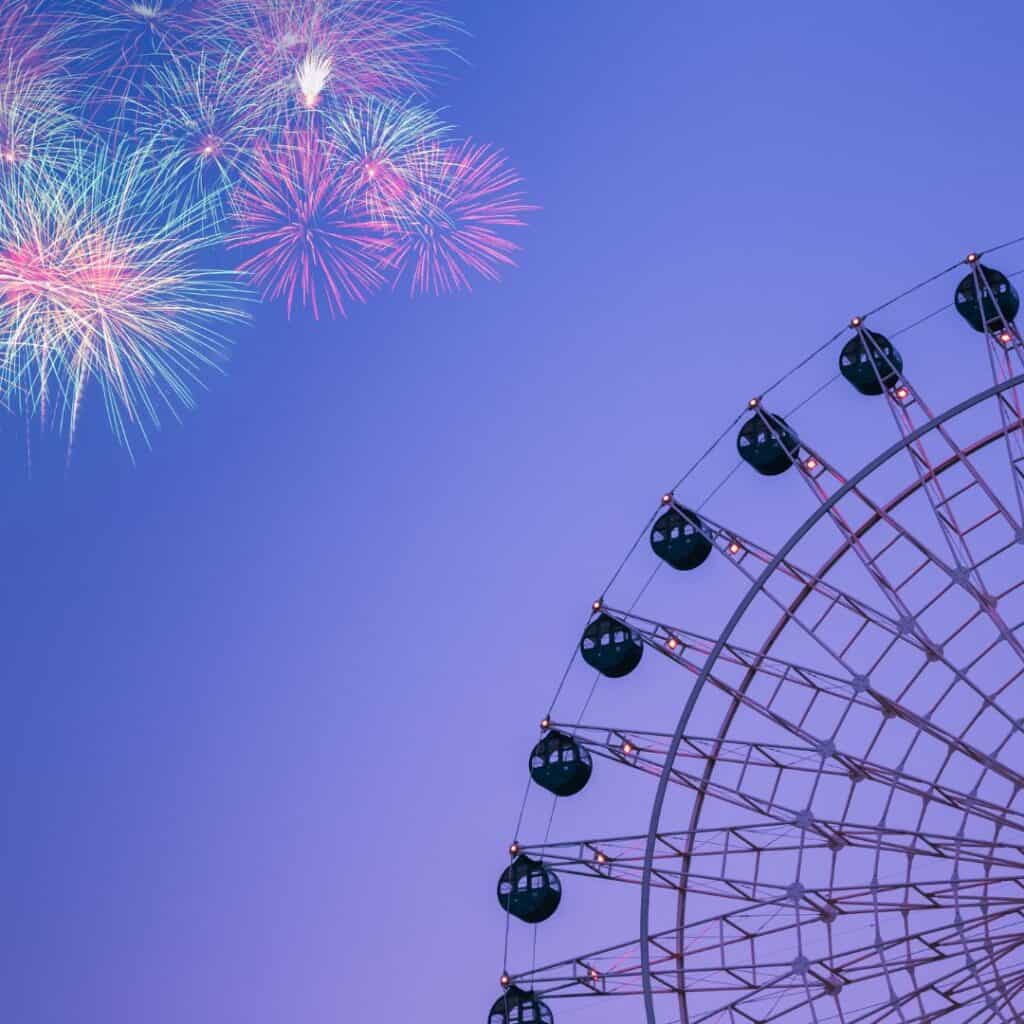 a ferris wheel with colorful fireworks in the sky