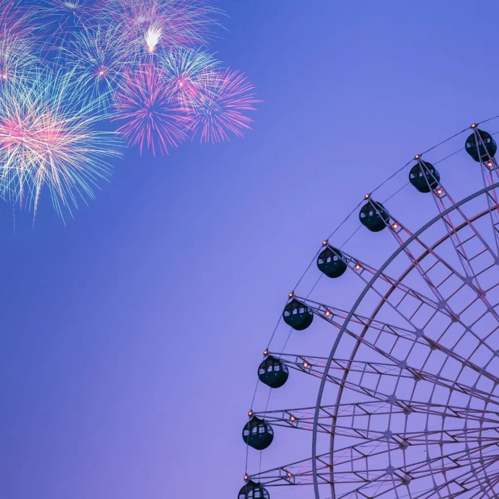 a ferris wheel with colorful fireworks in the sky