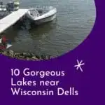 a boat docked at the end of a dock next to a lake