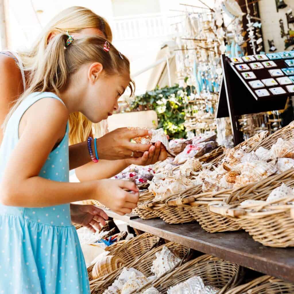 Mother and daughter shopping for souvenirs at a local market in Paros, Greece