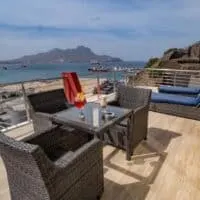 balcony with lounge and table overlooking the sea at Blue Marlin Hotel in Mindelo, cape verde. Best Hotels in Sao Vicente