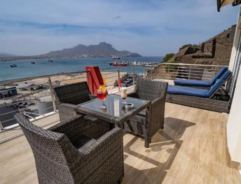 balcony with lounge and table overlooking the sea at Blue Marlin Hotel in Mindelo, cape verde