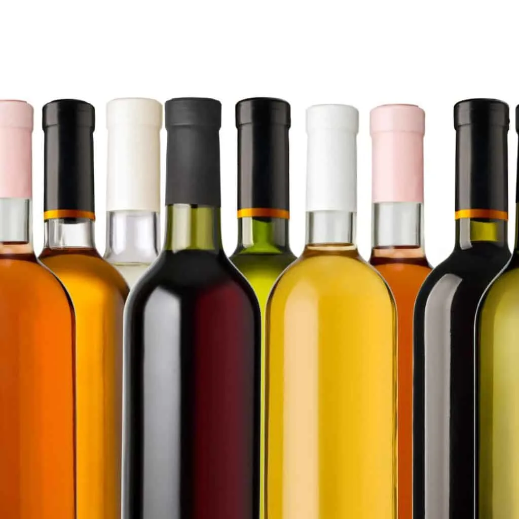 bottles of wine with different flavors on a white background