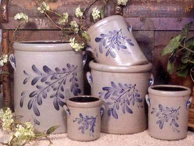 a group of vases with leaves painted on them