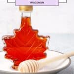 maple syrup in a glass bottle with a wooden spoon