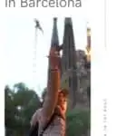 A person with arms outstretched in front of Sagrada Familia, Barcelona, Spain