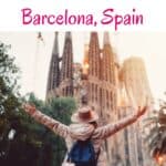 A person with arms outstretched in front of Sagrada Familia, Barcelona, Spain