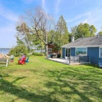 lawn with garden furniture and lake access at the Rustic Lakefront Cabin in Sturgeon Bay, Door county. door county cheap cabins