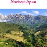 A scenic landscape in Northern Spain featuring a valley with rolling green hills, mountains in the distance, and a small village nestled among the trees. The text 