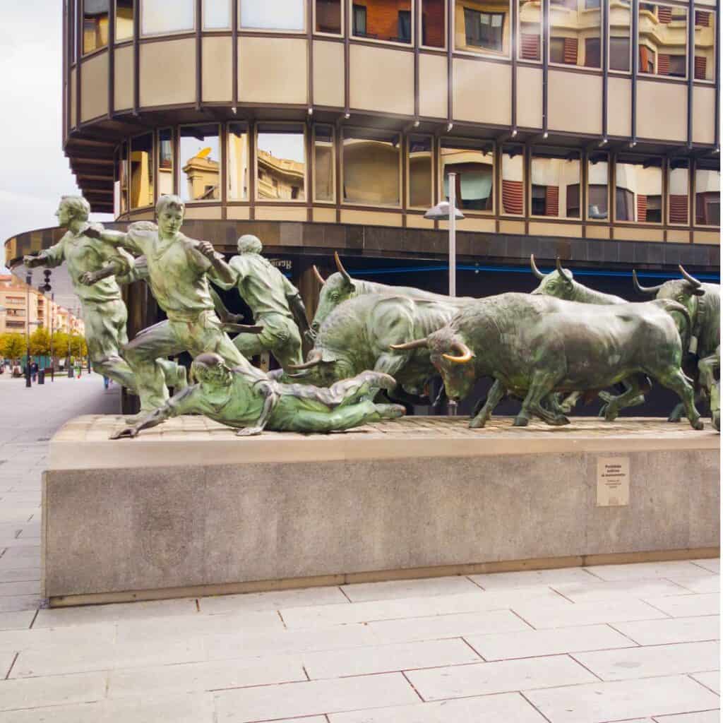 The Encierro/Entzierroa Monument in Pamplona, Spain, depicting a group of people running away from charging bulls.