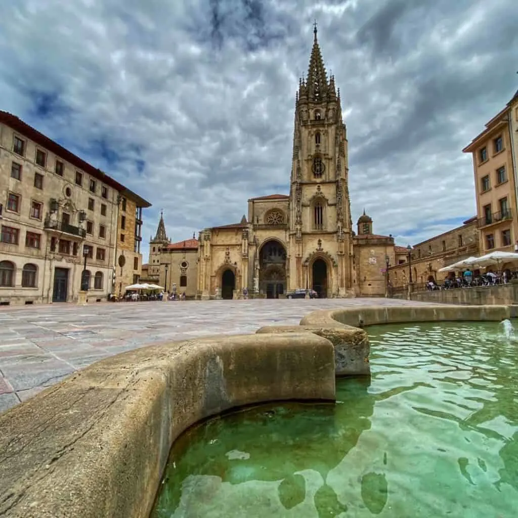 The Cathedral of San Salvador in Oviedo, Spain, a Gothic cathedral with a tall spire and a large square in front.