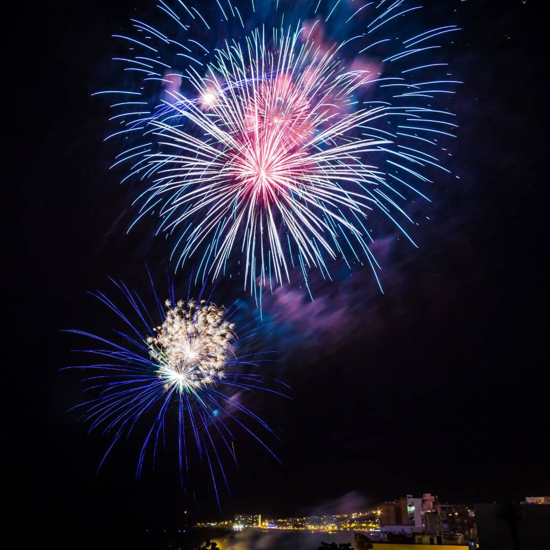 fireworks in the night sky over the ocean