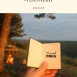a pin with a travel book in the hand of a man. best books about wisconsin