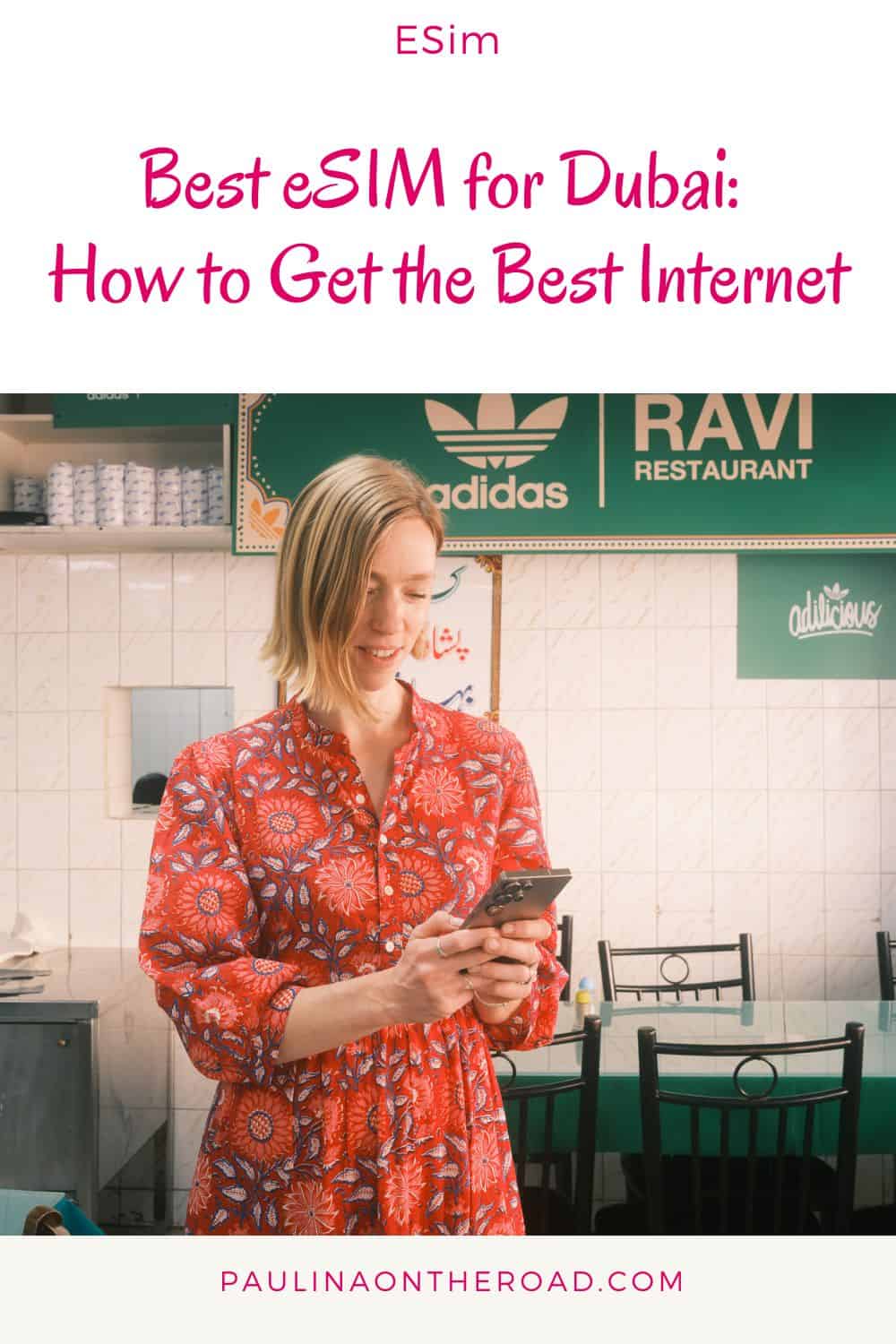 a woman in a red dress in a restaurant looking at her phone