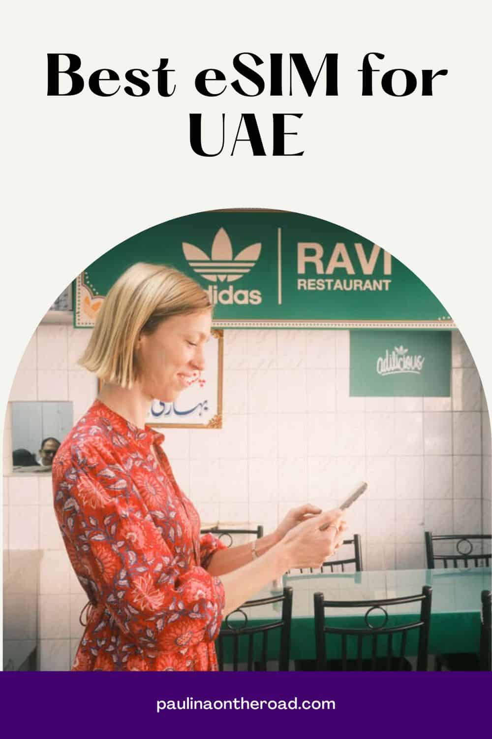 a woman in a red dress in a restaurant looking at her phone