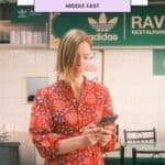 a woman looking at her phone in a restaurant