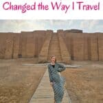a woman wearing a dress behind is the Great Ziggurat of Ur, a massive step pyramid located near Nasiriyah in present-day Iraq