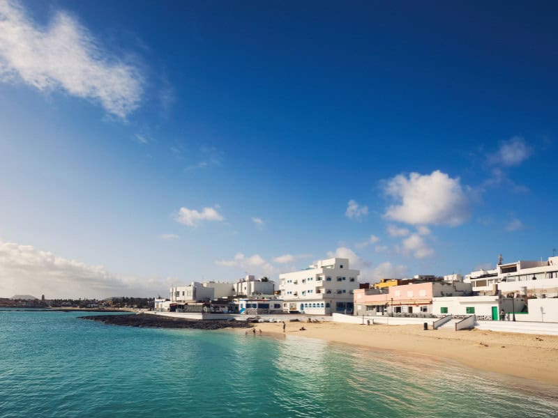 Hotel in Fuerteventura a beach with a view of resorts and houses and Hotel in Fuerteventura